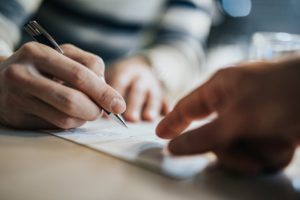 Client signing legal documents regarding their estate
