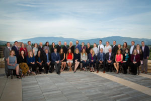 Worden Thane Lawyers pose for group photo on a rooftop, Missoula, Montana skyline and mountain scenery