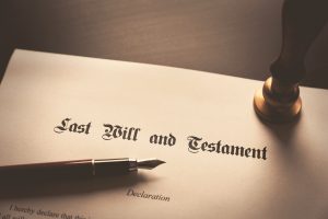 "Last Will and Testament" written on paper on a desk