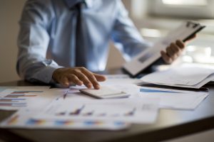 Business person reviewing finances and debt, secure funding with equity