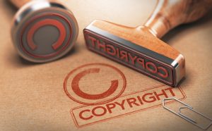 Red copyright stamp on brown paper, protect your intellectual property