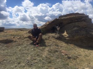 Martin King posing with his dog on a hike