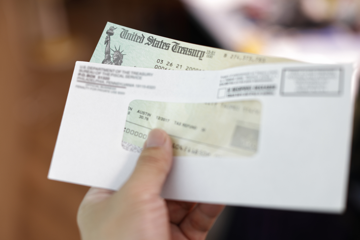 Man holding a tax refund check Worden Thane