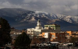 Missoula Montana courthouse with snow-covered mountains in the background.