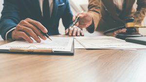 Lawyers reviewing legal documents regarding trademark and copyright.